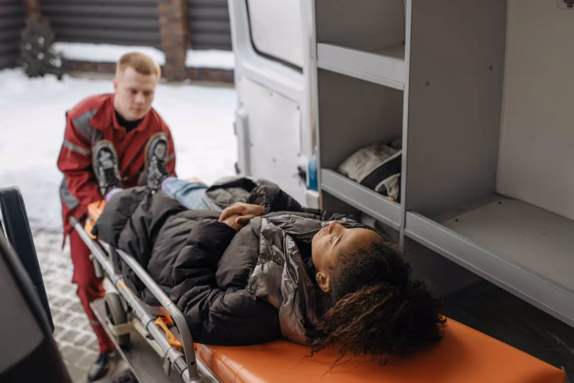 The woman on the stretcher inside the ambulance